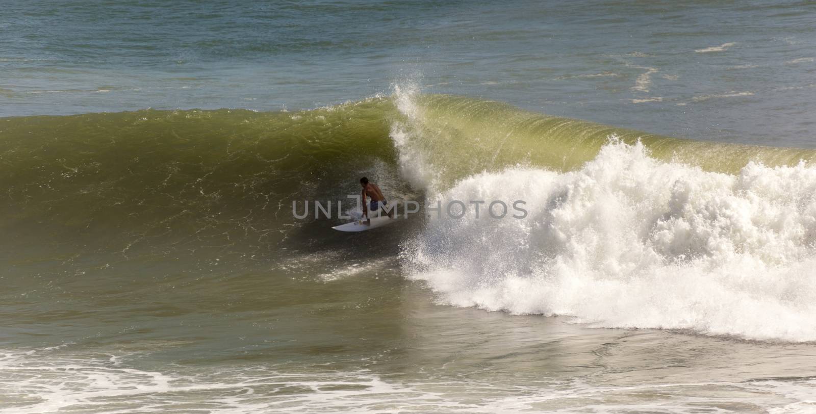 Surfer races the Quiksilver & Roxy Pro World Title Event.  2012 by Imagecom