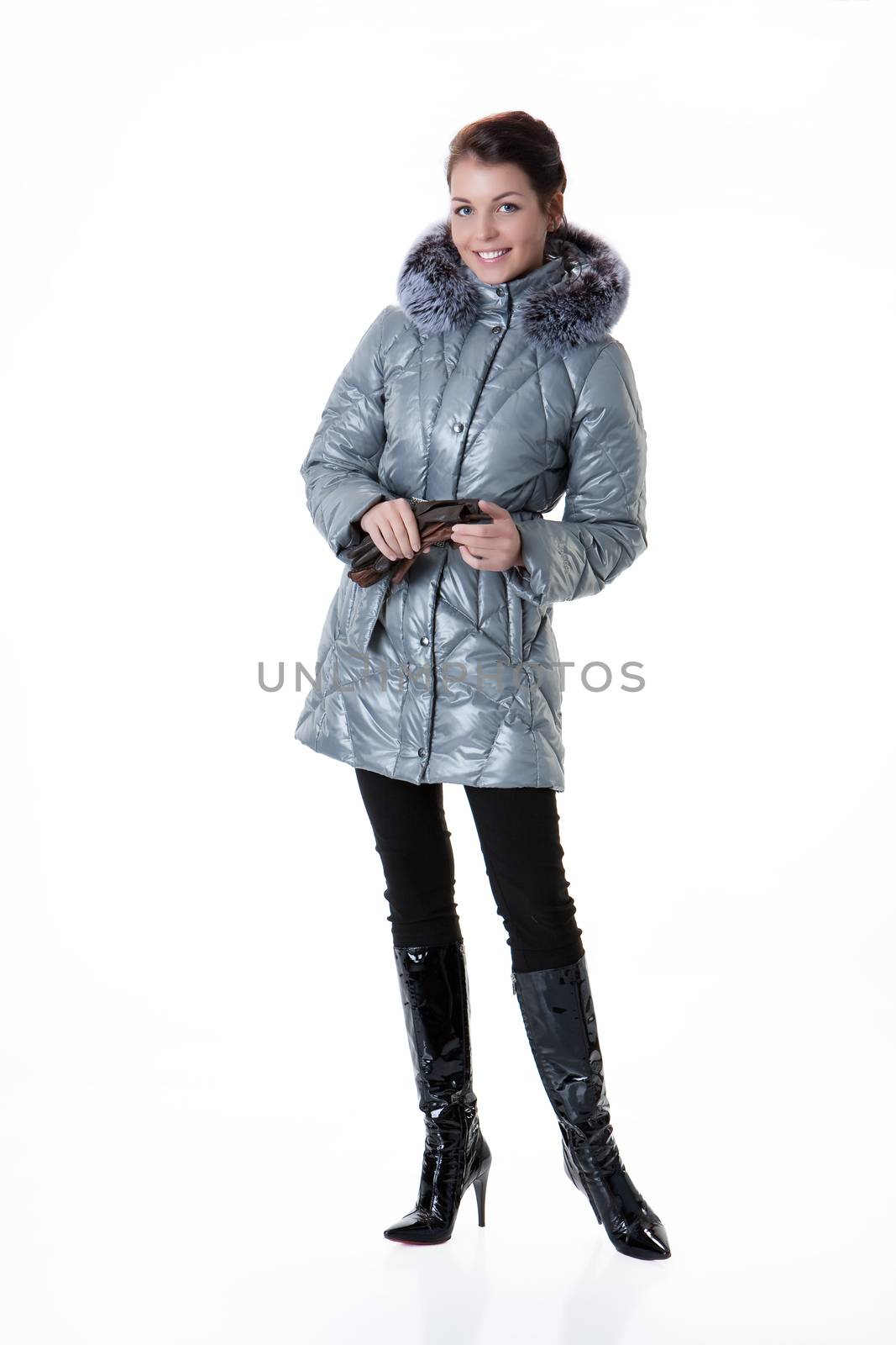 Young beautiful woman in fashionable winter warm clothing on isolated studio background