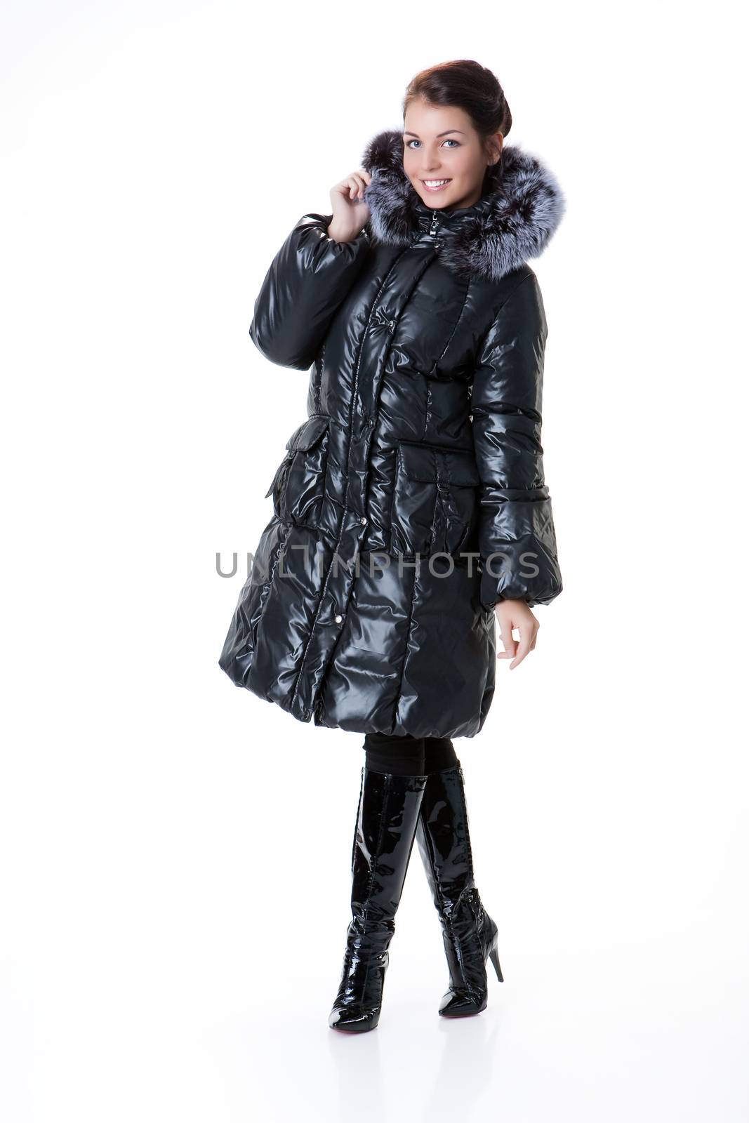 Young beautiful woman in fashionable winter warm clothing on isolated studio background