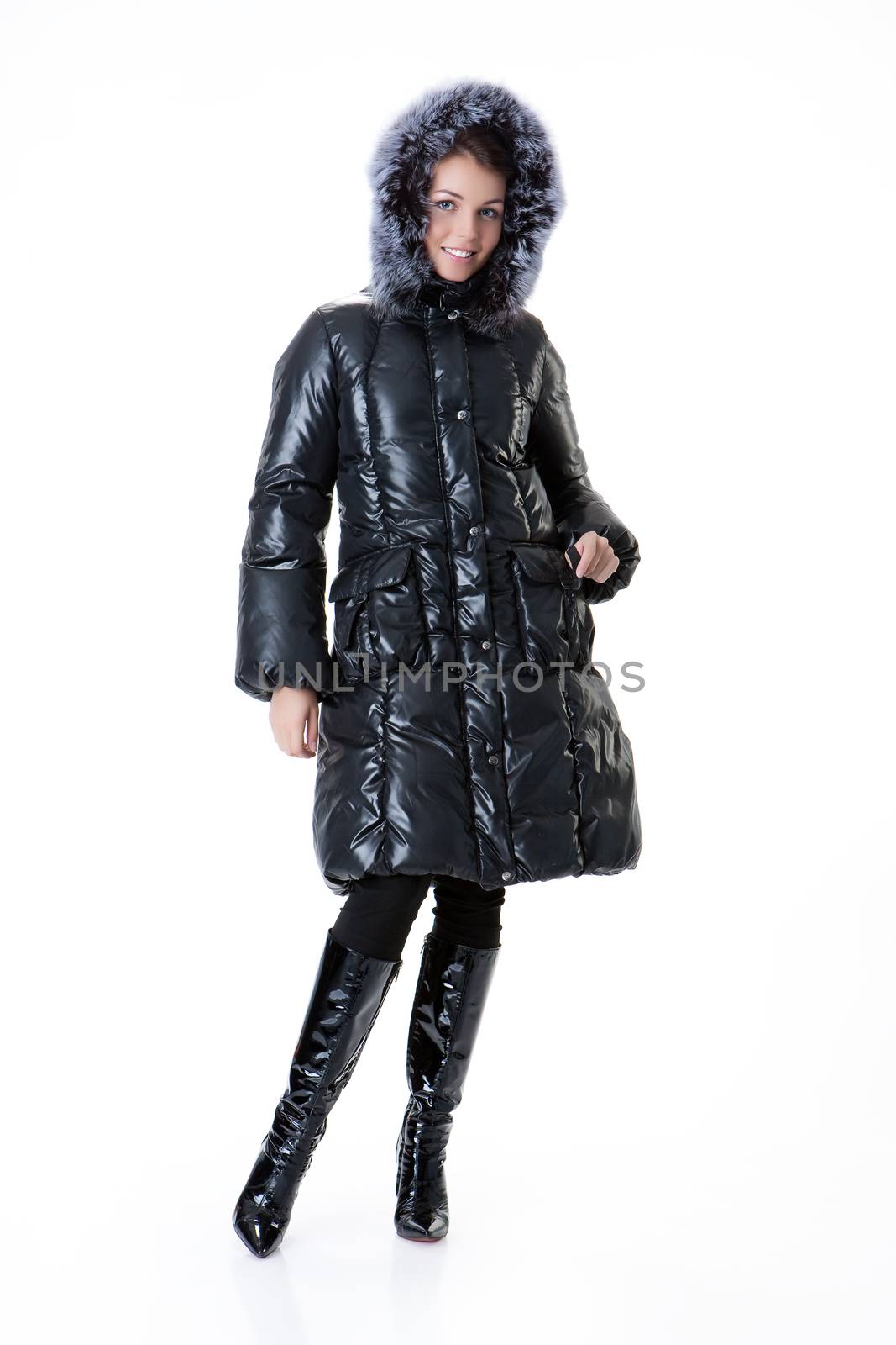 Young beautiful woman in fashionable winter warm clothing on isolated studio background