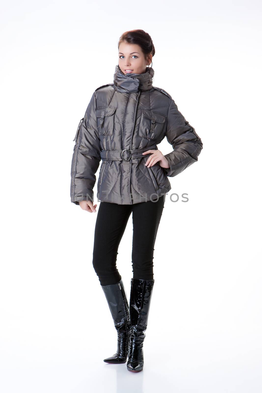 Young beautiful woman in fashionable winter warm clothing on isolated studio background