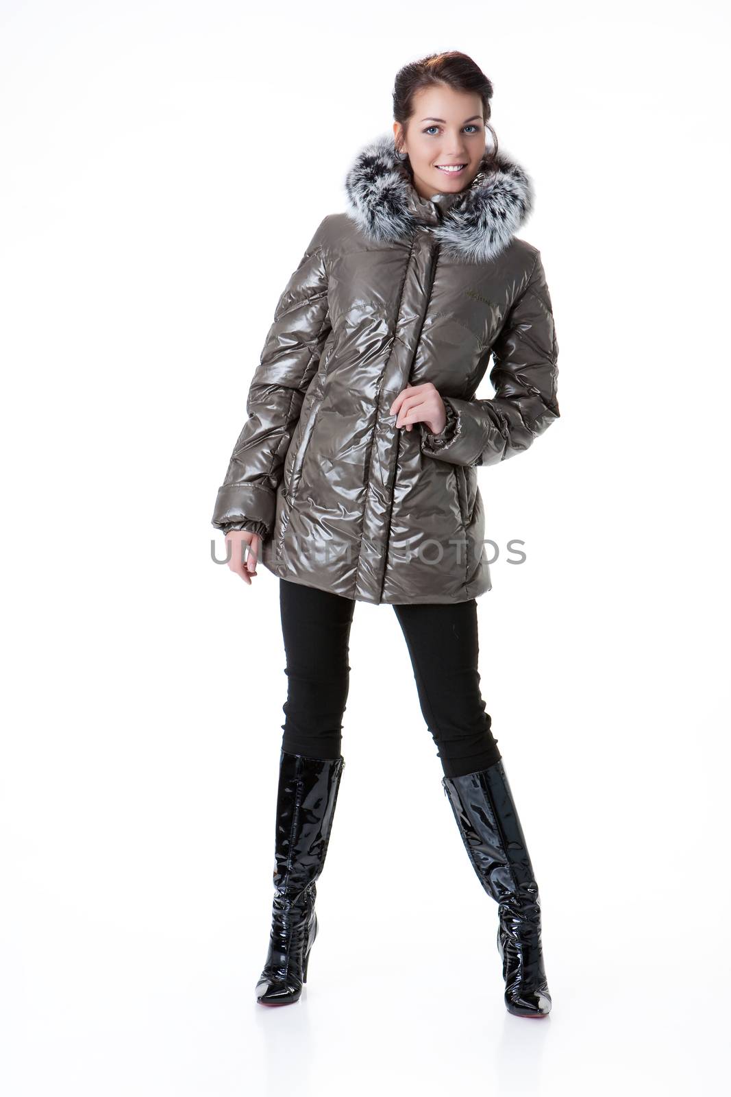 Young beautiful woman in fashionable winter warm clothing on isolated studio background