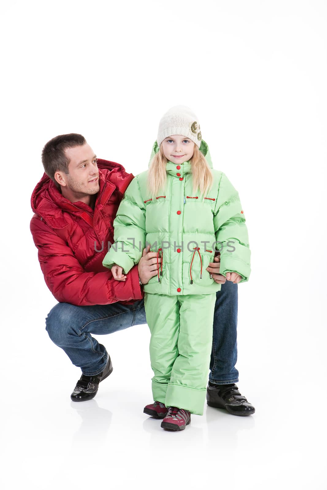 Young man and girl in winter clothing on isolated studio baclground