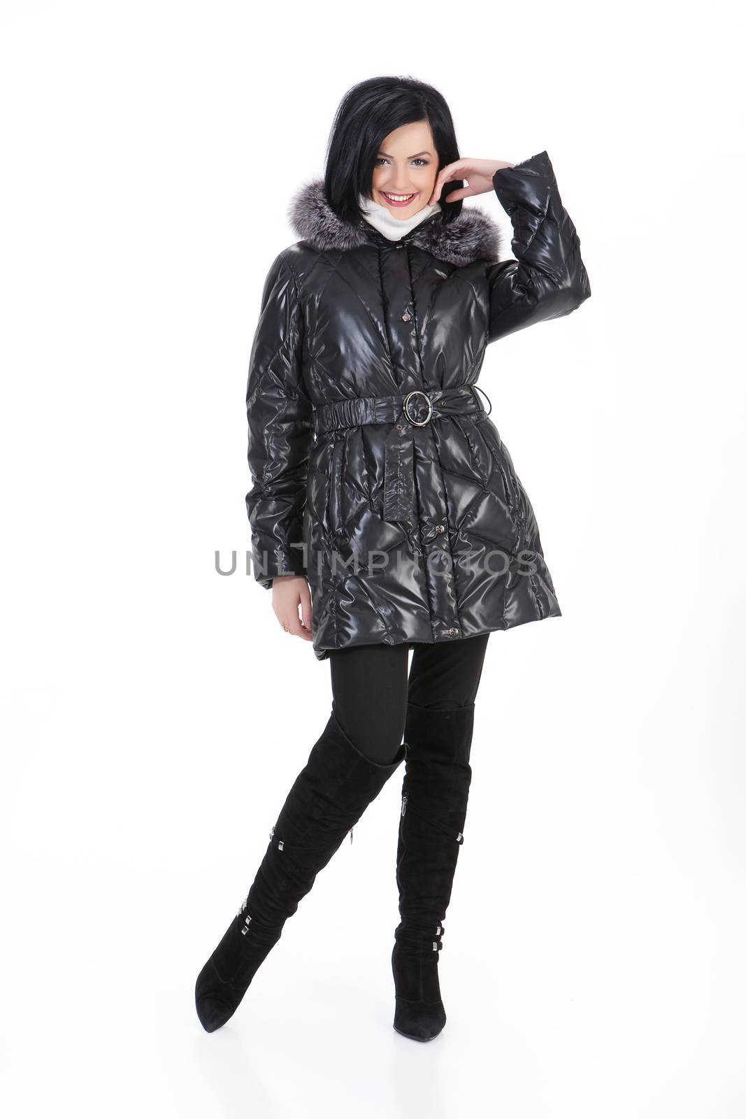 Young beautiful woman in fashionable winter warm clothing on isolated studio background