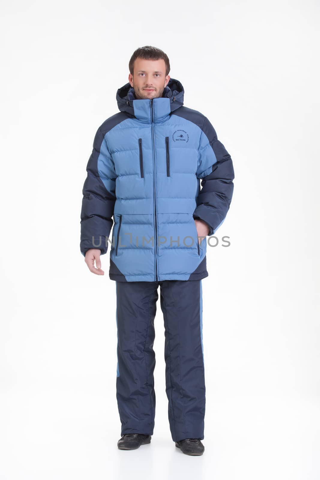 Young man in fashionable winter clothing on isolated studio background