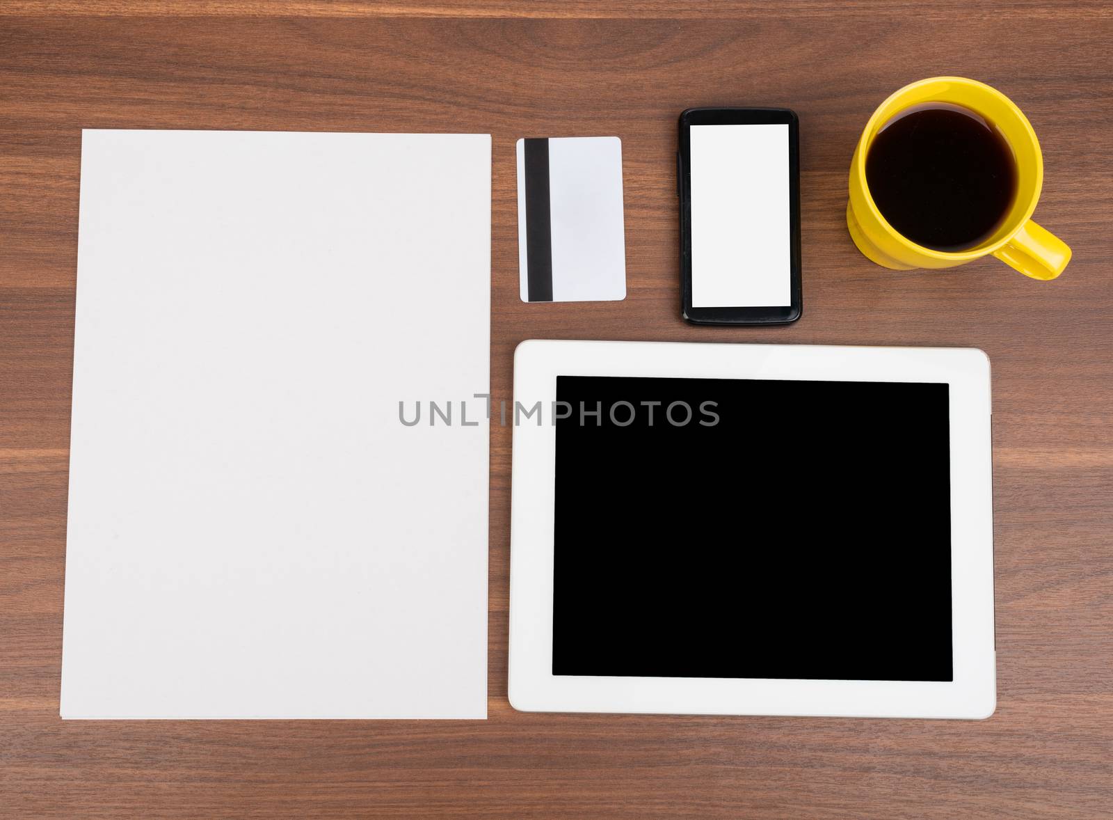 Blank paper with smartphone and blank card on wooden table