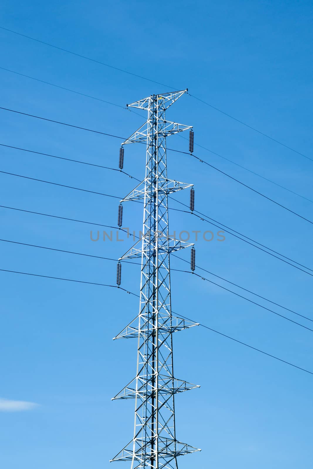 High voltage post or power transmission line tower and blue sky by mranucha