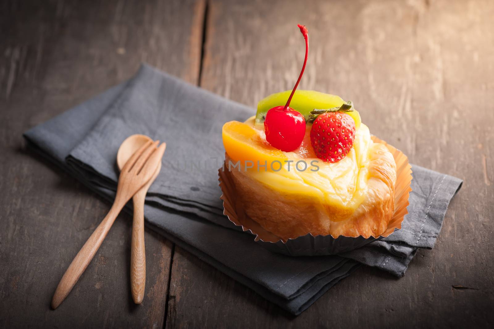 Fruit danish pastry on wood table in morning time