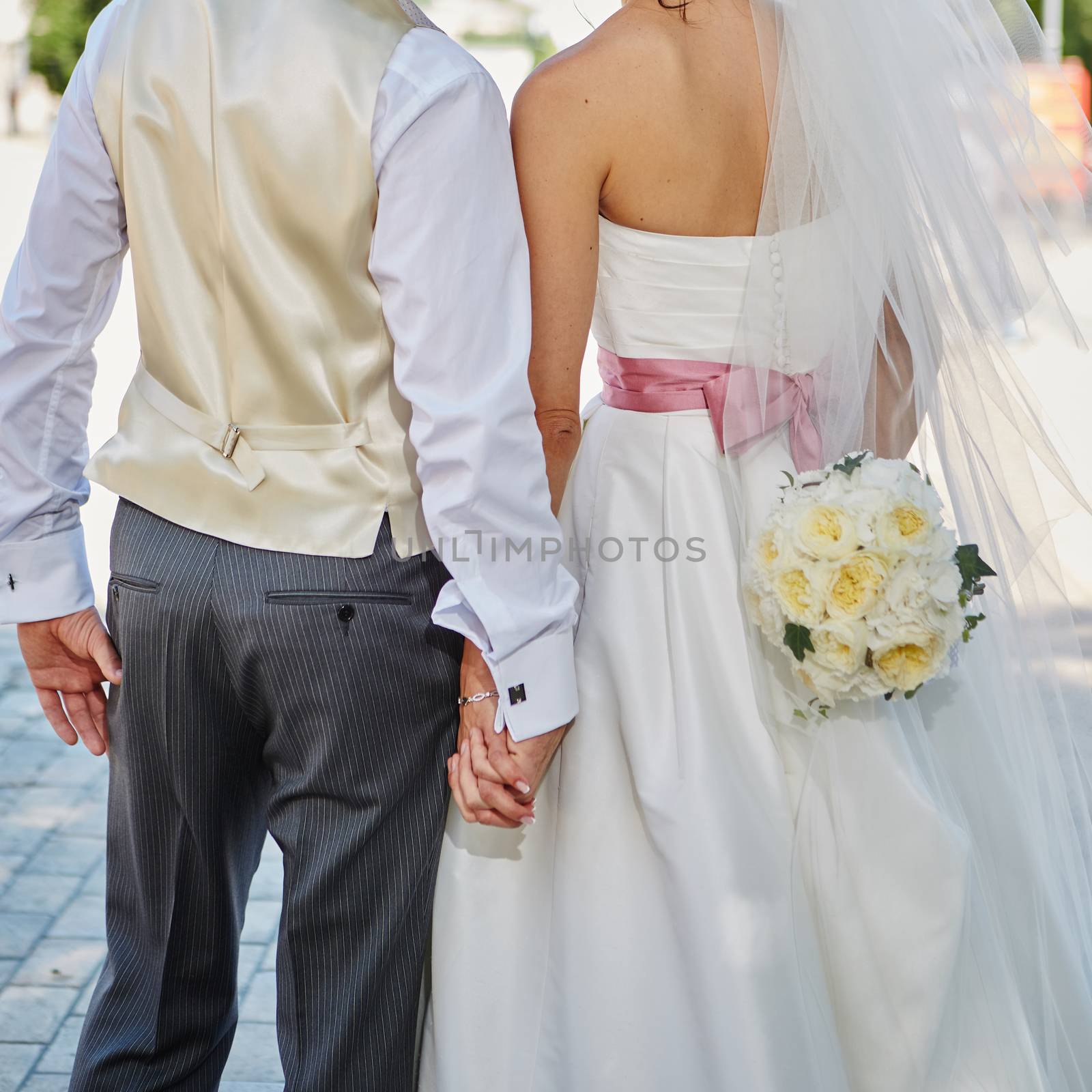 Elegant bride and groom posing together outdoors on a wedding day