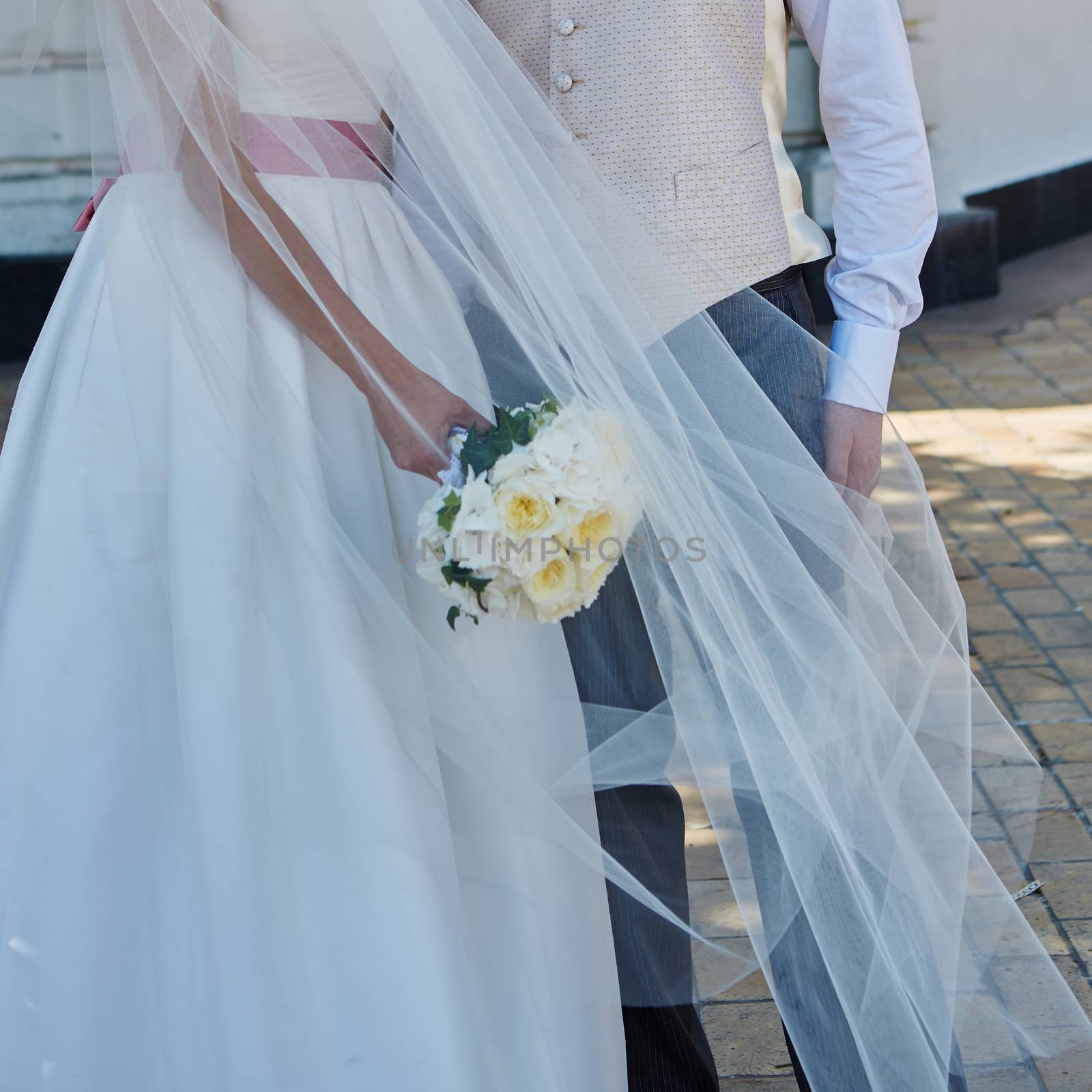 Elegant bride and groom posing together outdoors on a wedding day