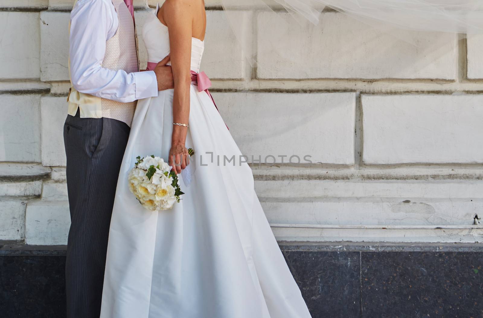 Elegant bride and groom posing together outdoors on a wedding day