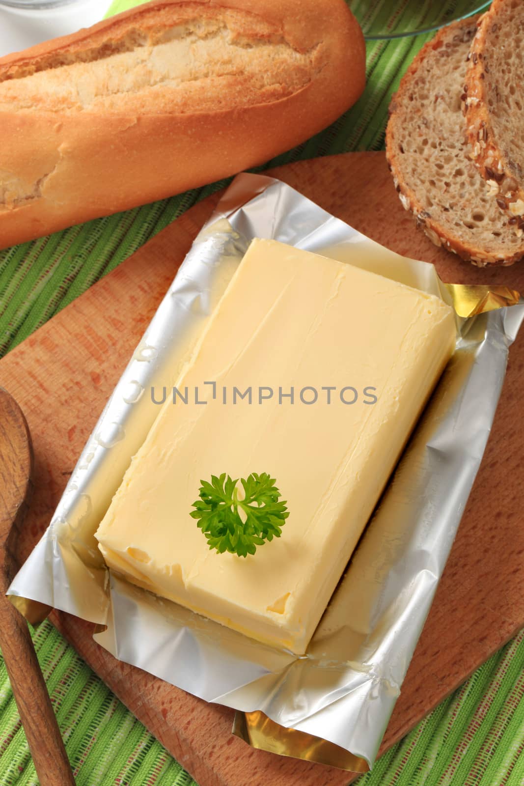 Block of fresh butter and bread - closeup