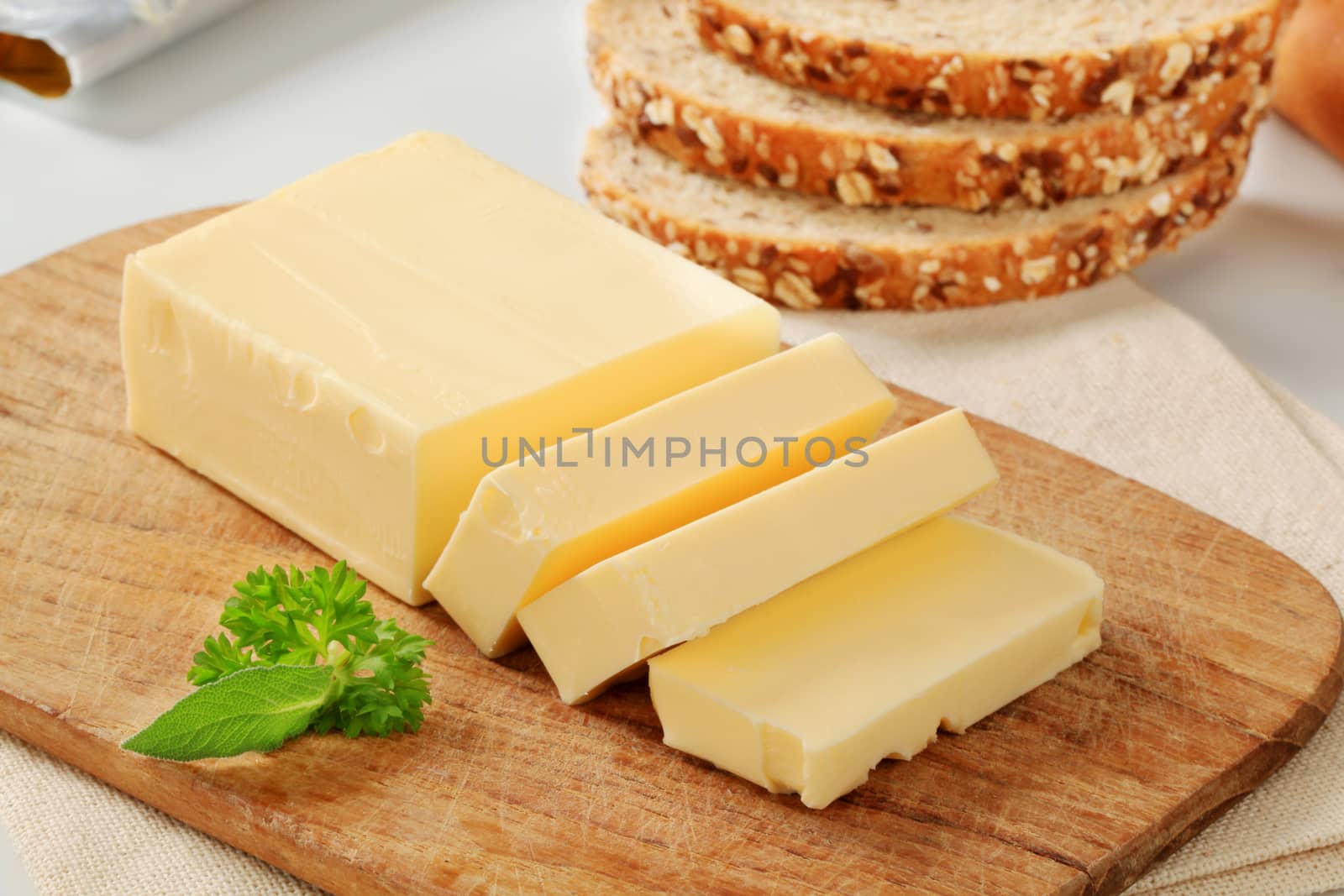 Block of fresh butter  on a cutting board