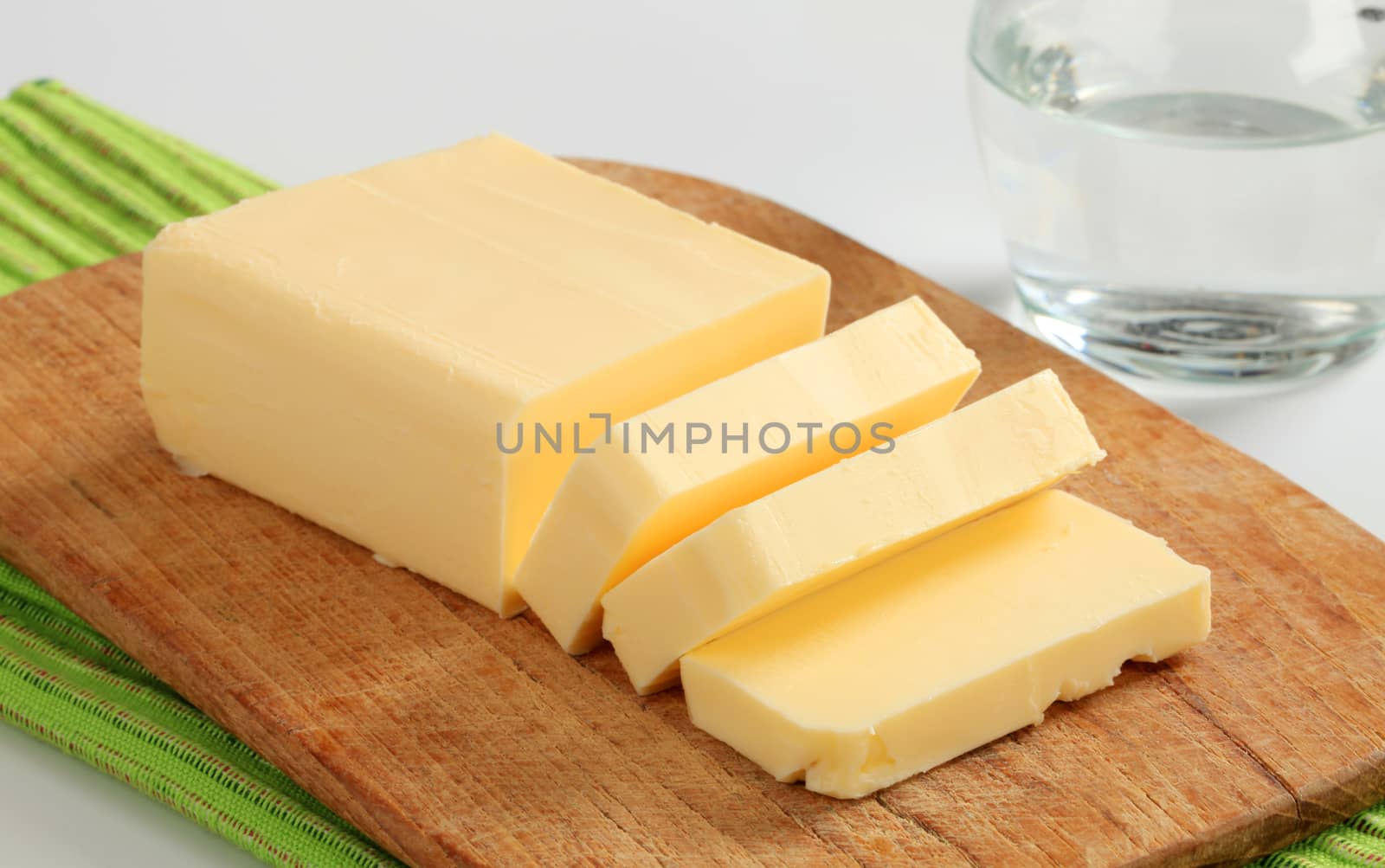 Block of fresh butter  on a cutting board