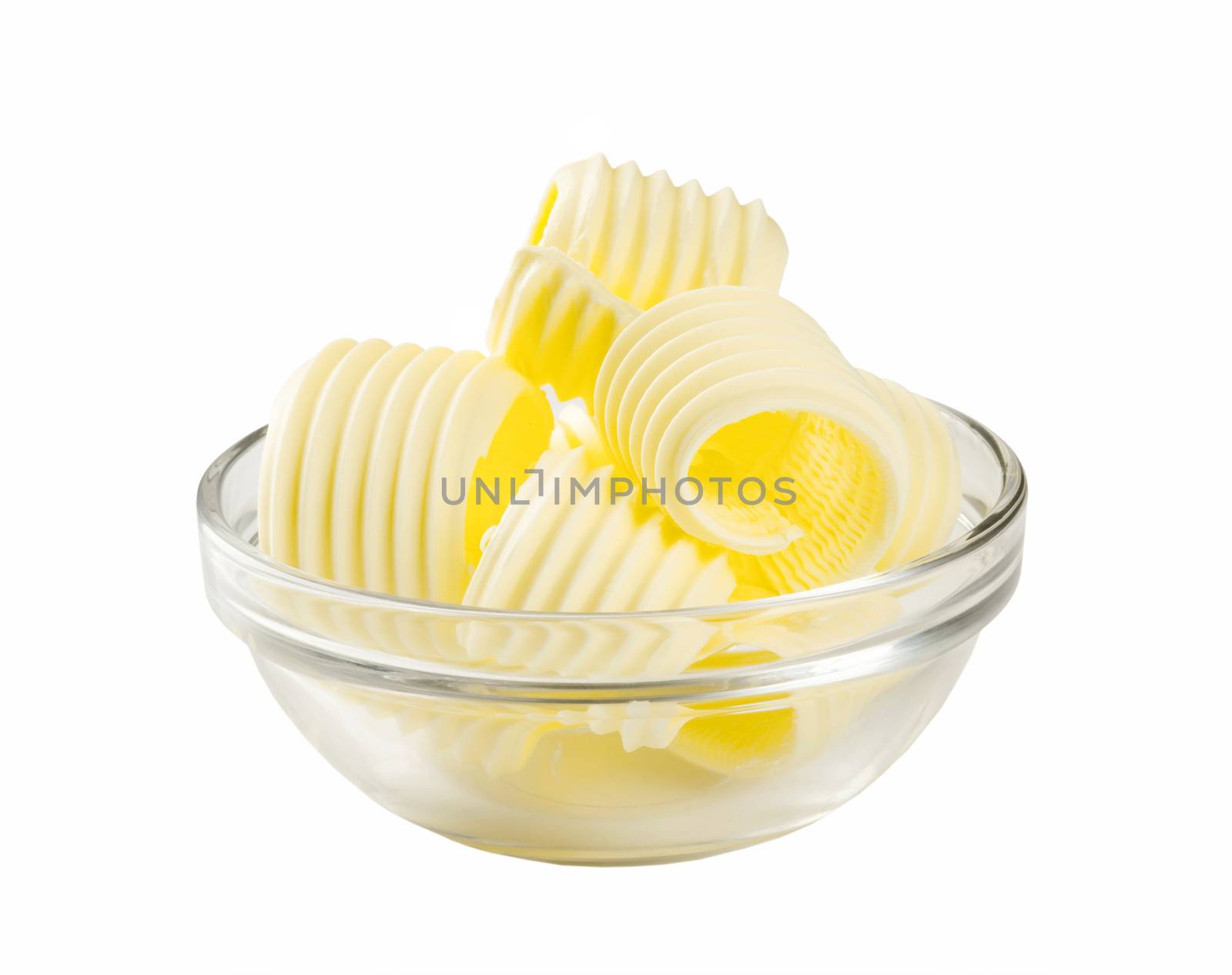 Butter curls in a glass bowl isolated on white
