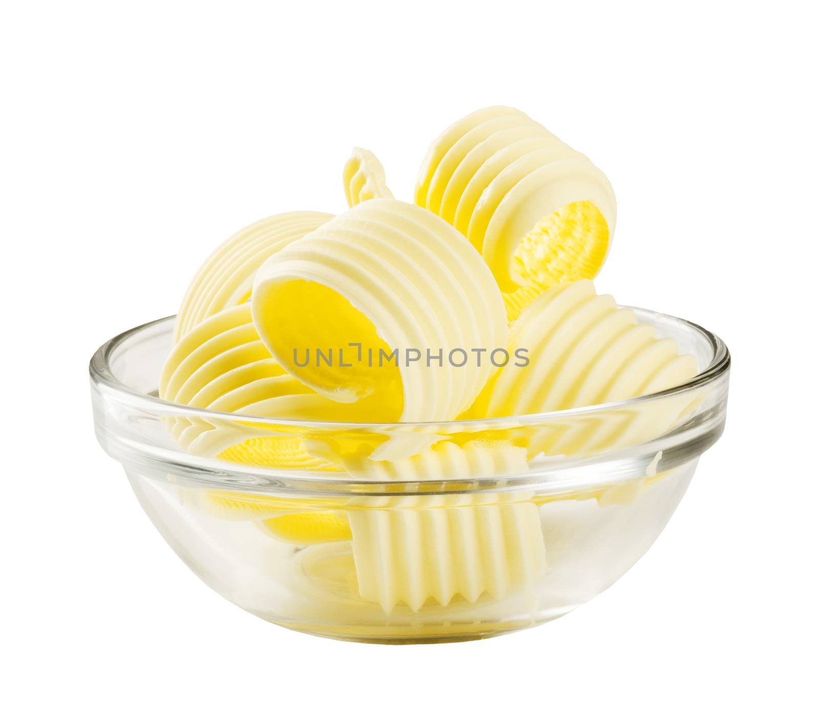 Butter curls in a glass bowl isolated on white