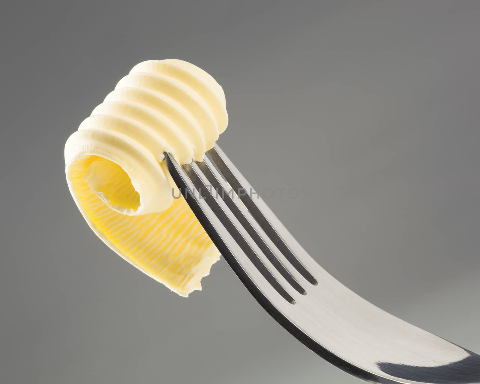 Closeup of a butter curl on a fork
