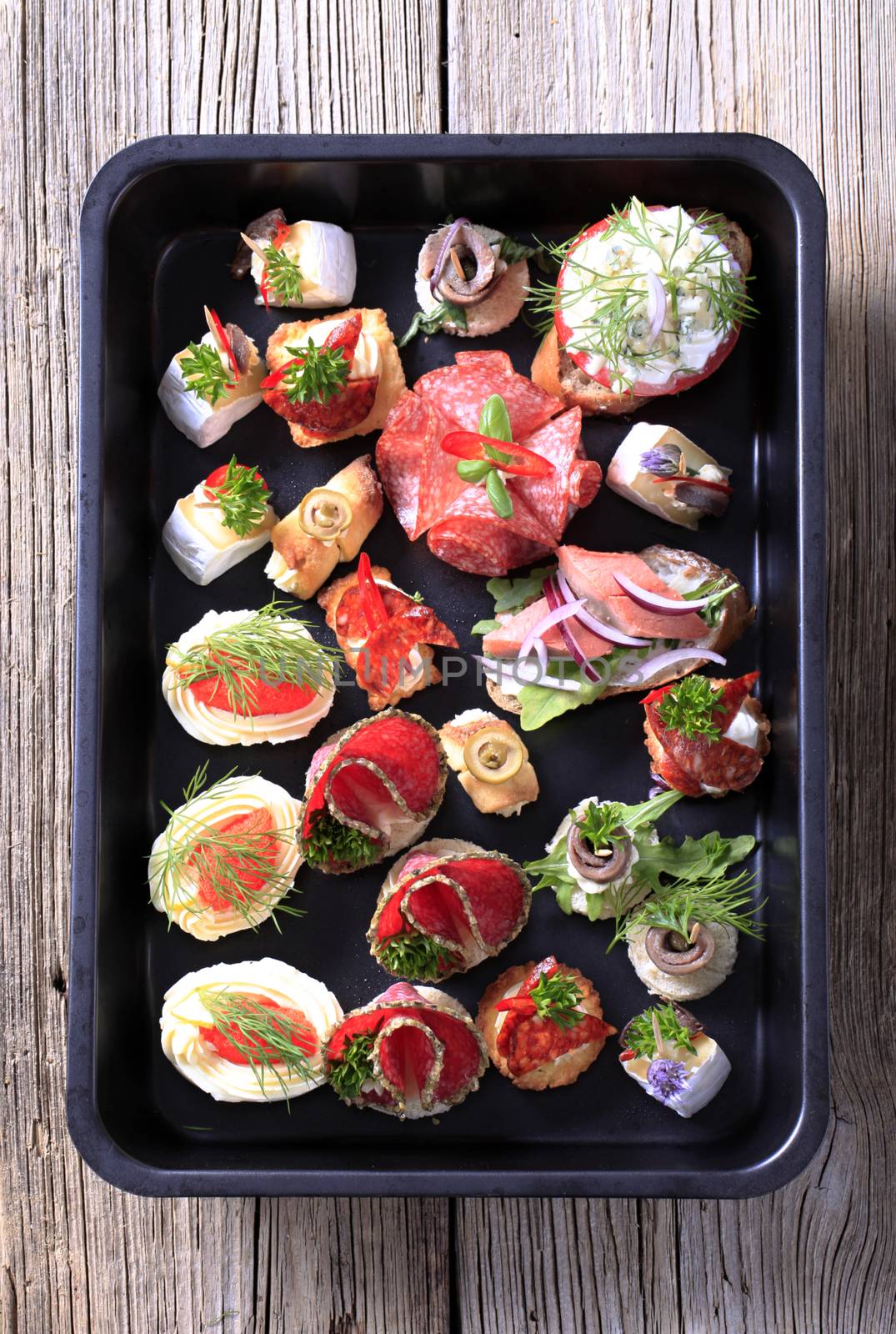 Assortment of hors d'oeuvre on a black tray