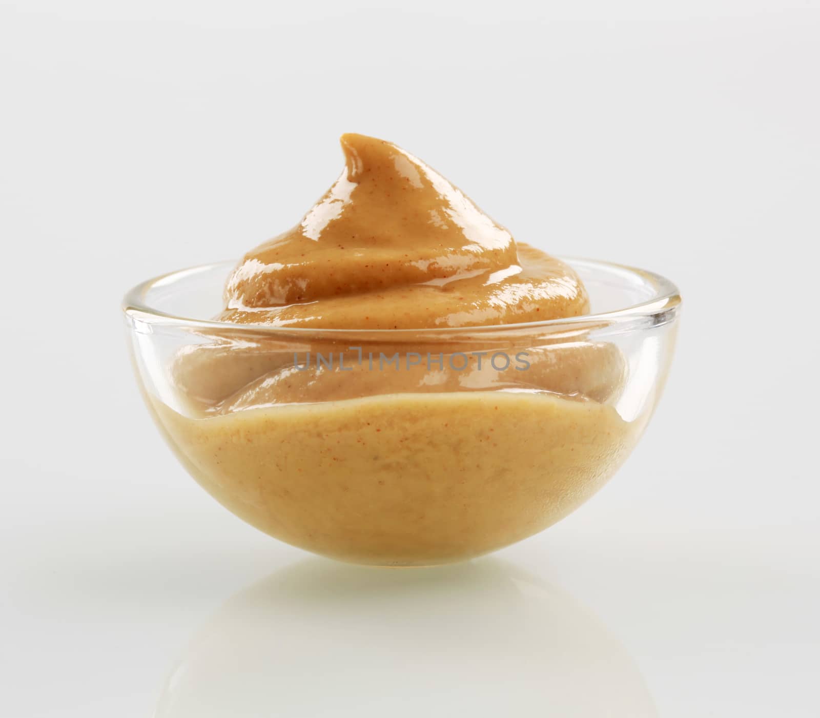 Swirl of spicy mustard in a bowl