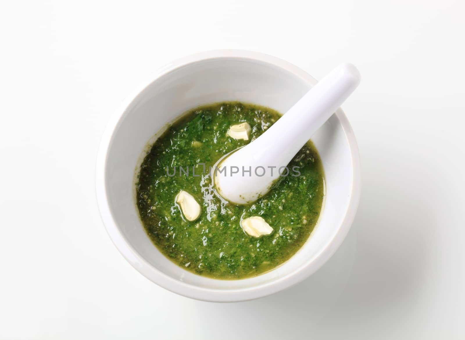 Basil pesto with crushed cashew nuts in a mortar