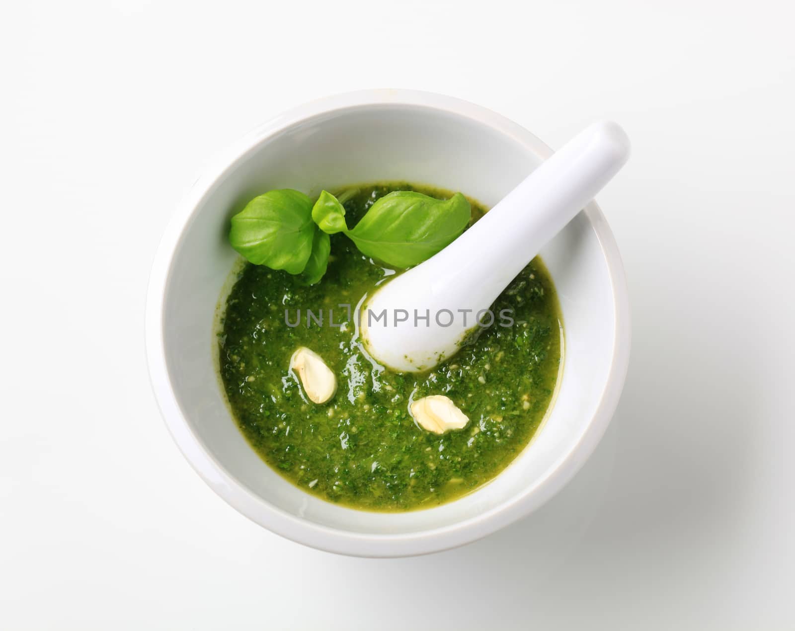 Basil pesto with crushed cashew nuts in a mortar
