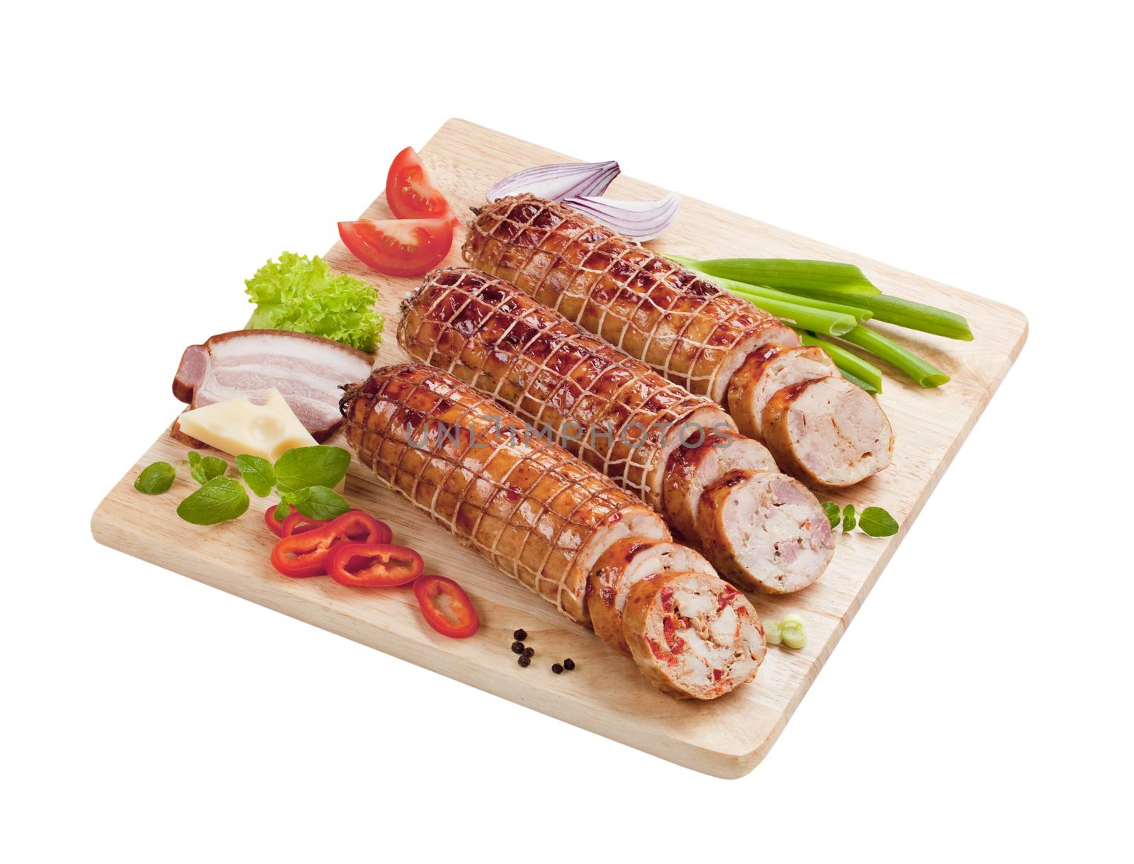 Roast pork and turkey rolls on a cutting board