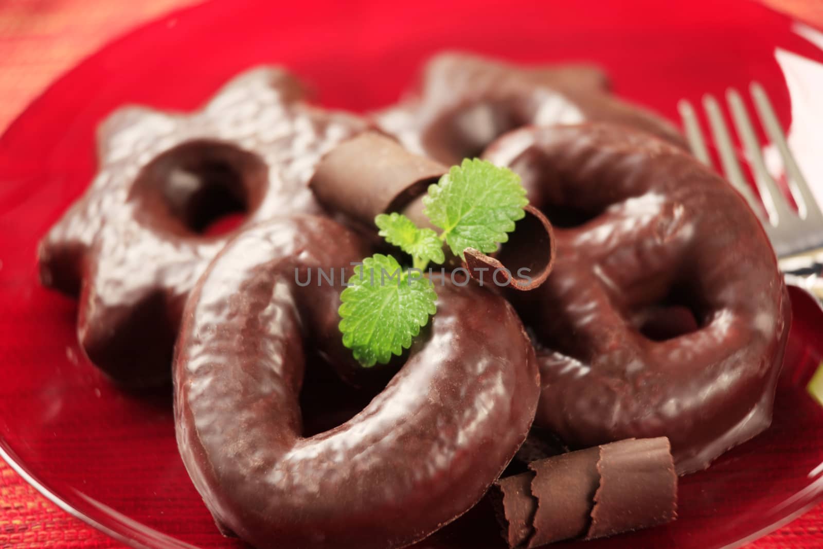 Chocolate covered gingerbread cookies on a red plate