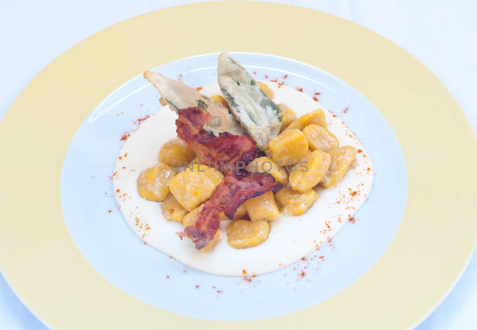 Gnocchi with pumpkin and peanut butter and crispy bacon,italy