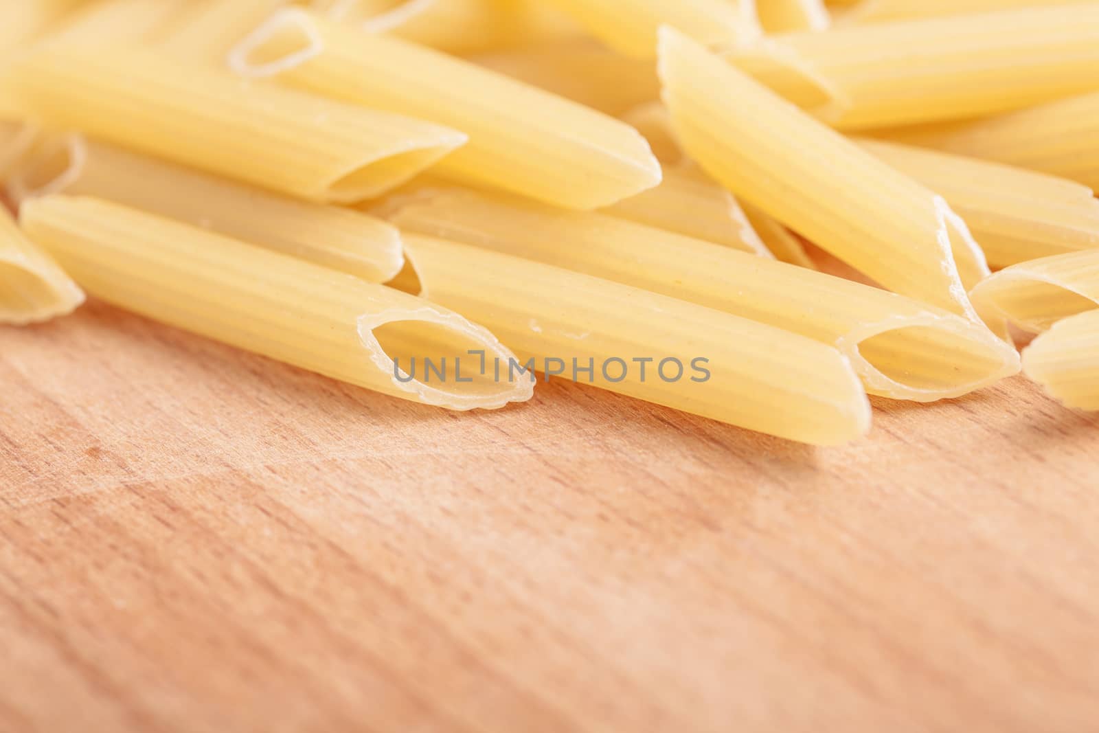 raw the pasta closeup on wooden background 