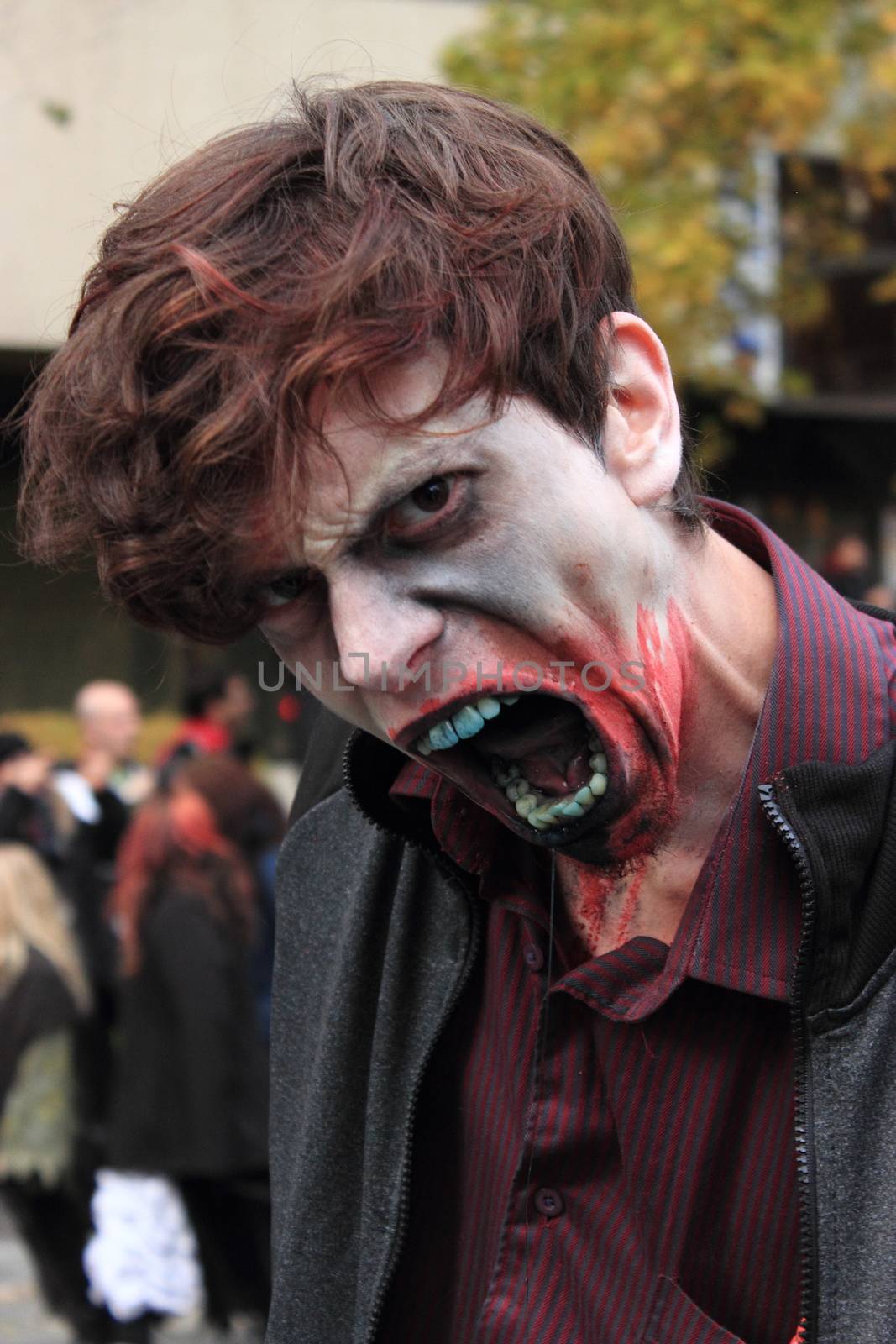 CANADA, Montreal: A man with fake blood in the face poses as he takes part in the Zombie Day of Montreal, on October 31, 2015.