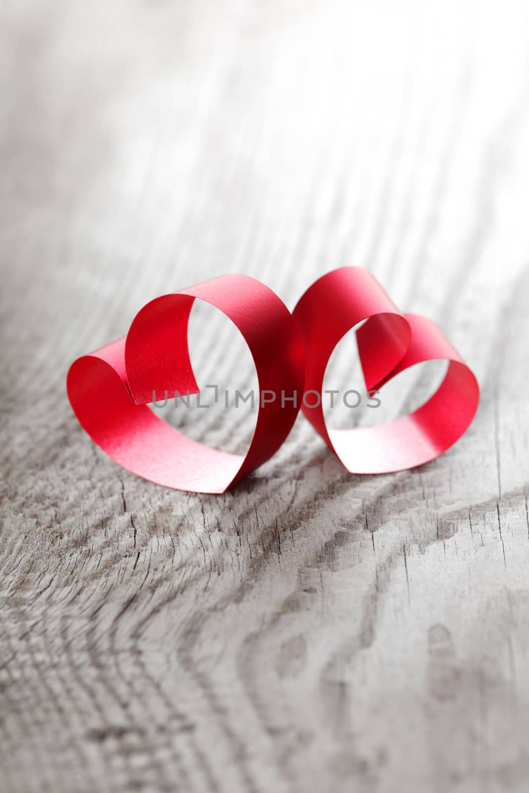 Red ribbon hearts on wooden background, Valentines day concept
