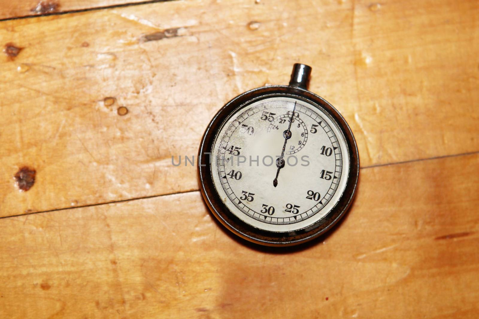 old and vintage stopwatch over a wooden surface