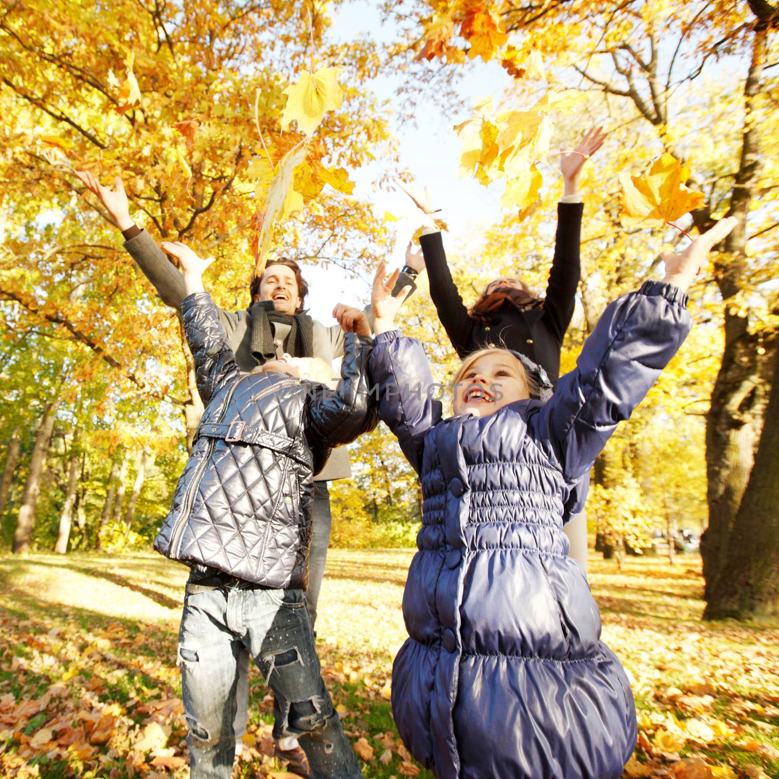 Family playing with autumn leaves  by ALotOfPeople