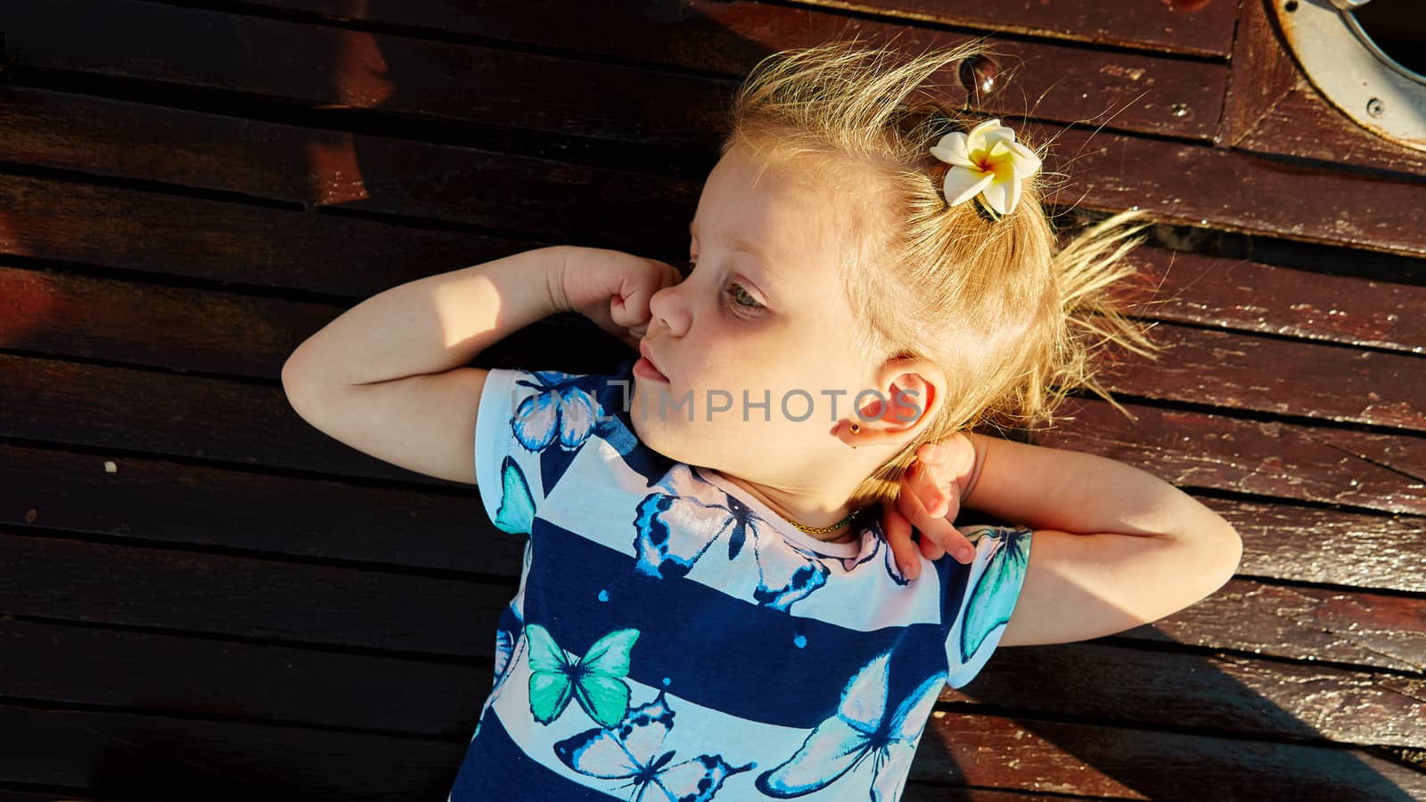 Little girl enjoying ride on yacht at sunset