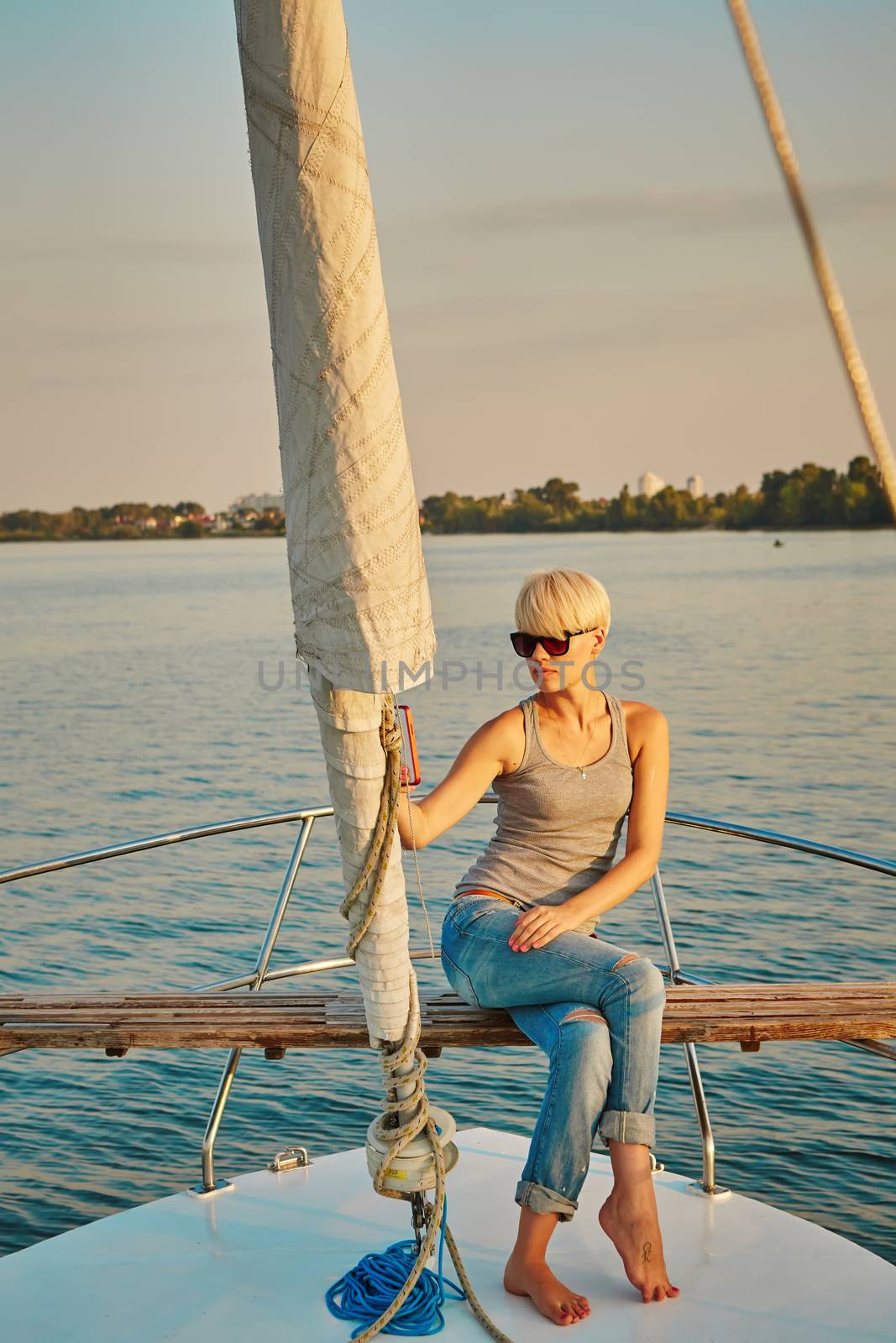 Pretty young female tourist makes selfie on yacht by sarymsakov