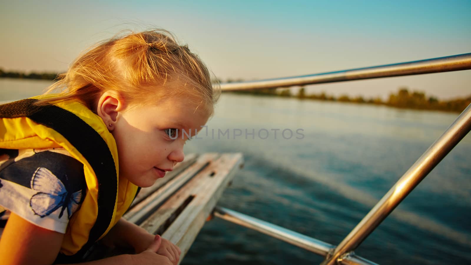 Little girl enjoying ride on yacht by sarymsakov