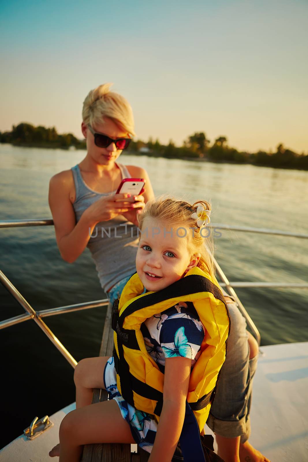 Mother, daughter on yacht or catamaran boat.  Concept of the family