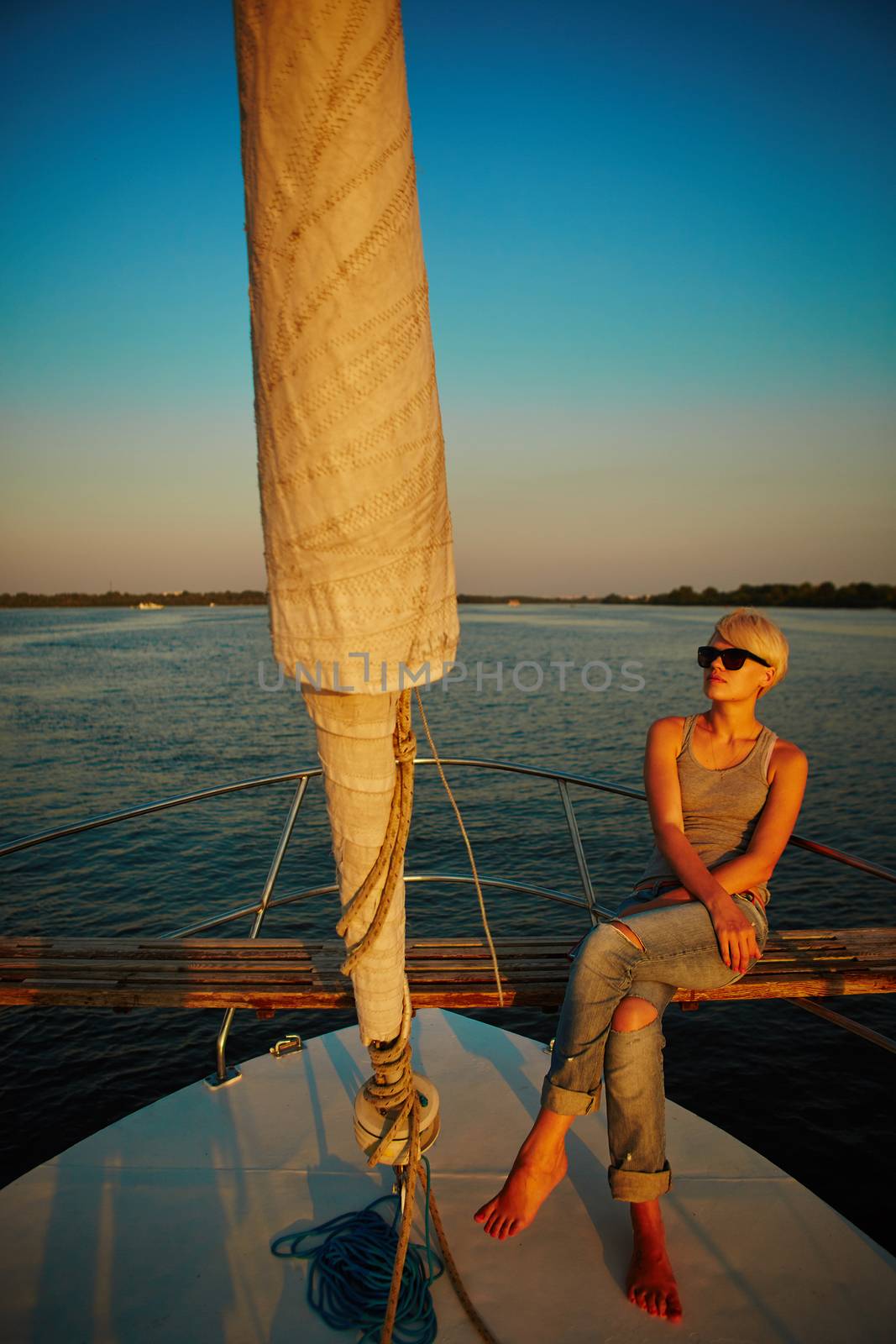 Woman traveling by boat at sunset among the river