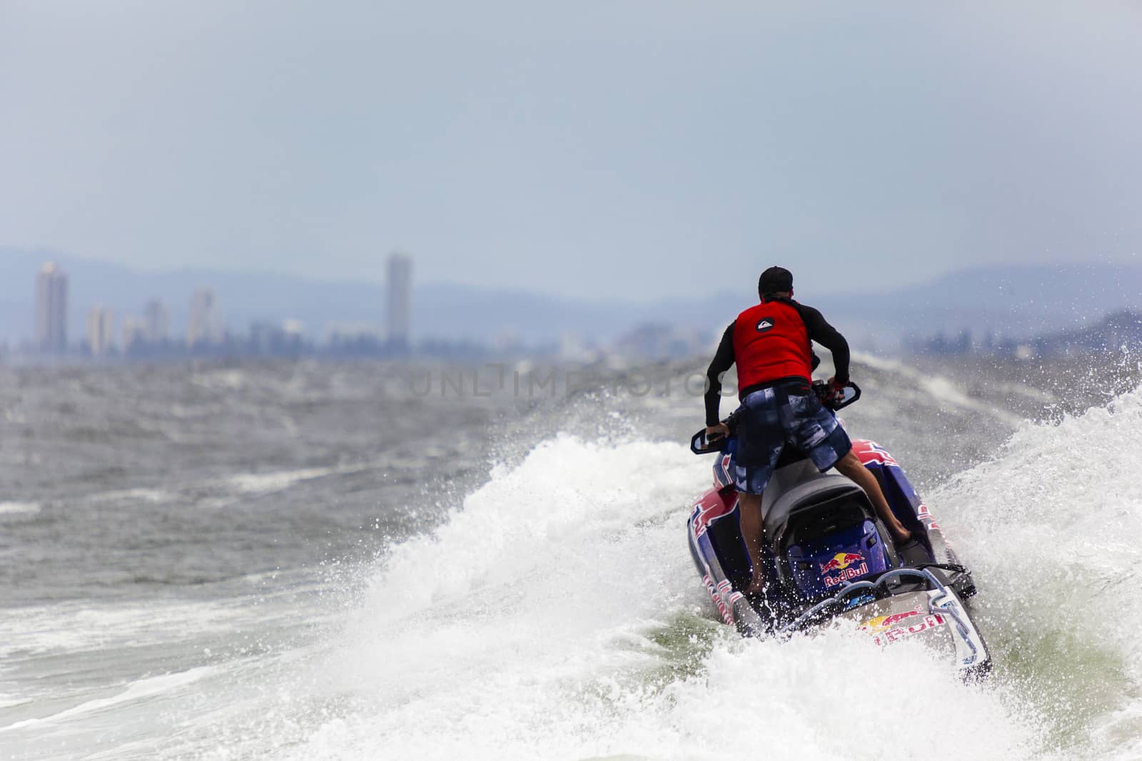 Surfer races the Quicksilver & Roxy Pro World Title Event by Imagecom