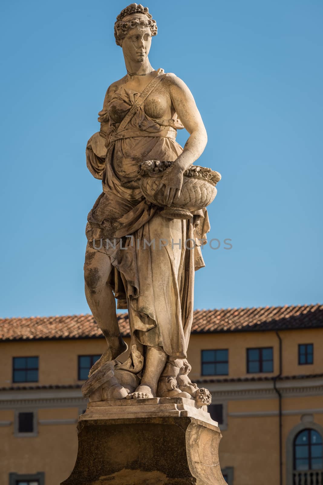 Statue on the bridge of Santa Trinita over the river Arno in Florence, Tuscany, Italy