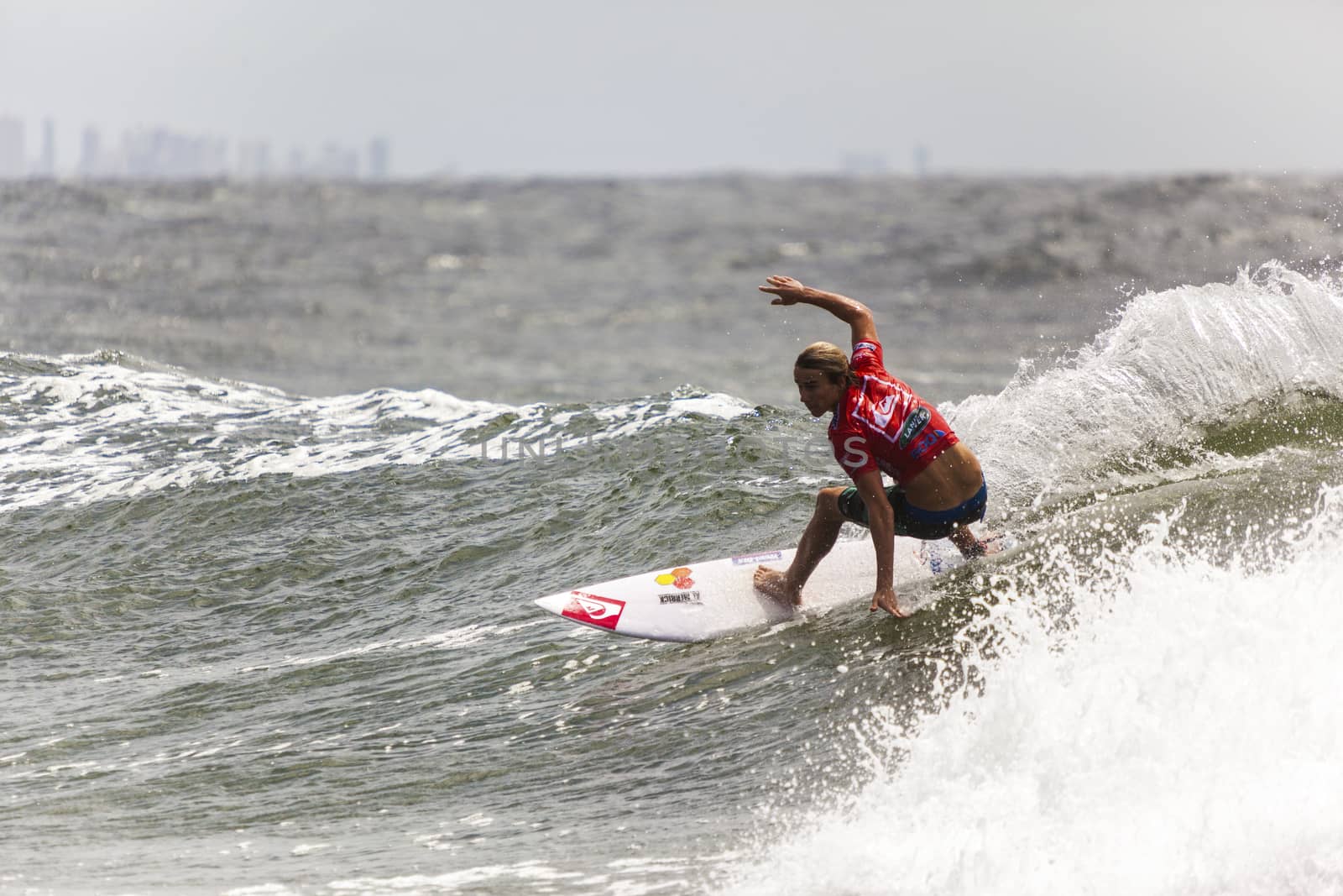 Surfer races the Quicksilver & Roxy Pro World Title Event by Imagecom