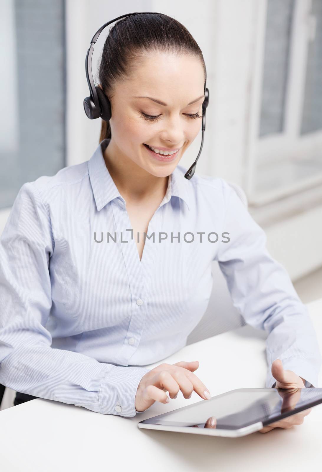 business, communication and call center concept - friendly female helpline operator with headphones and tablet pc comupter