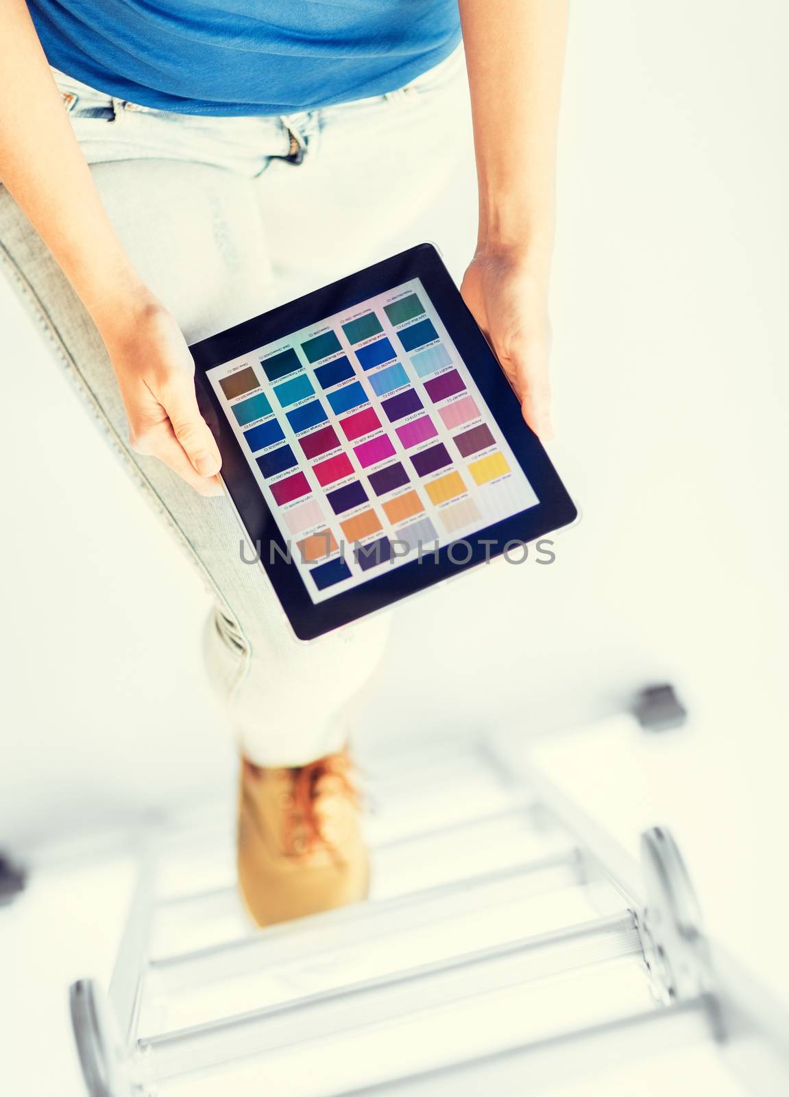 interior design, renovation and technology concept - woman working with color samples on tablet pc