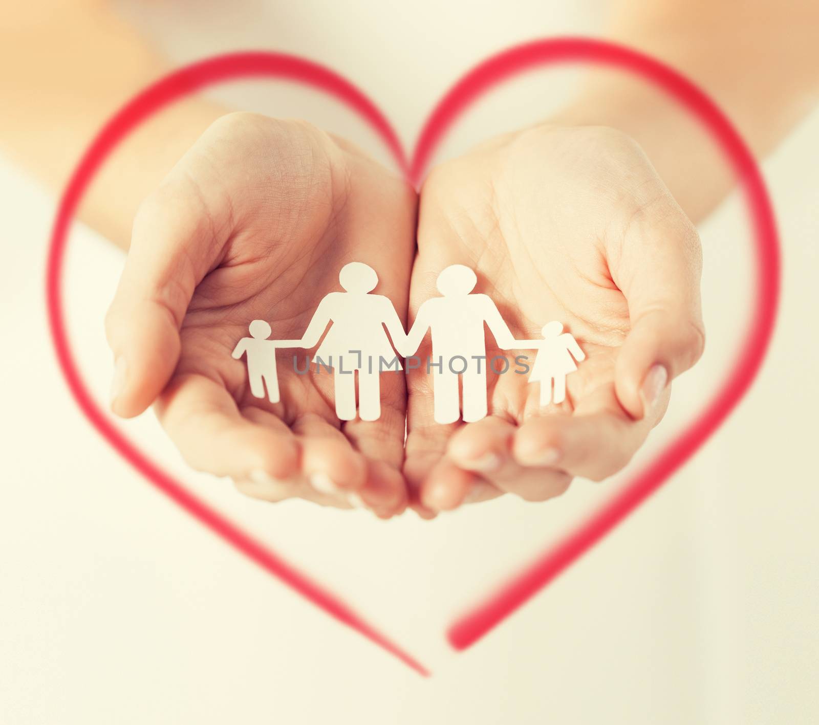 love, family and happiness concept - close up of womans hands showing paper man family