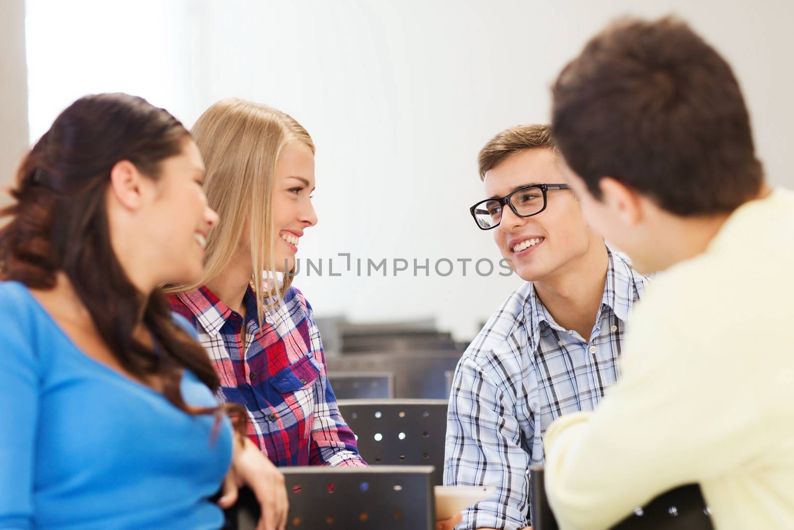 group of smiling students in lecture hall by dolgachov