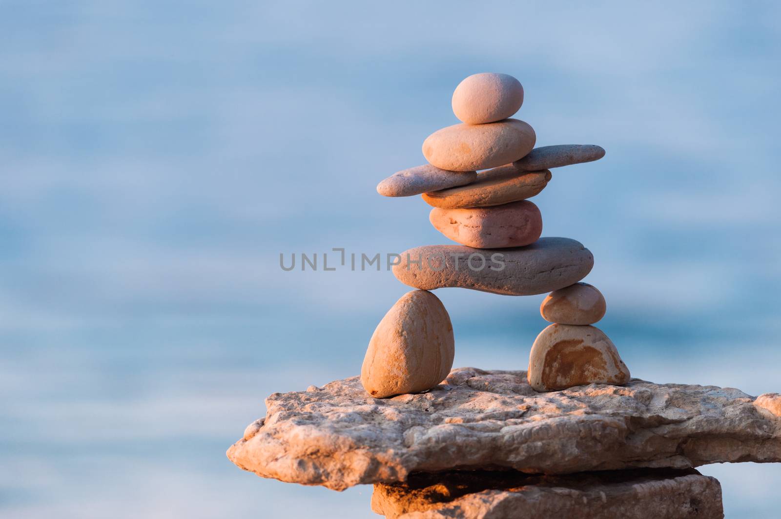 Figurine of Inukshuk of stones on the seacoast