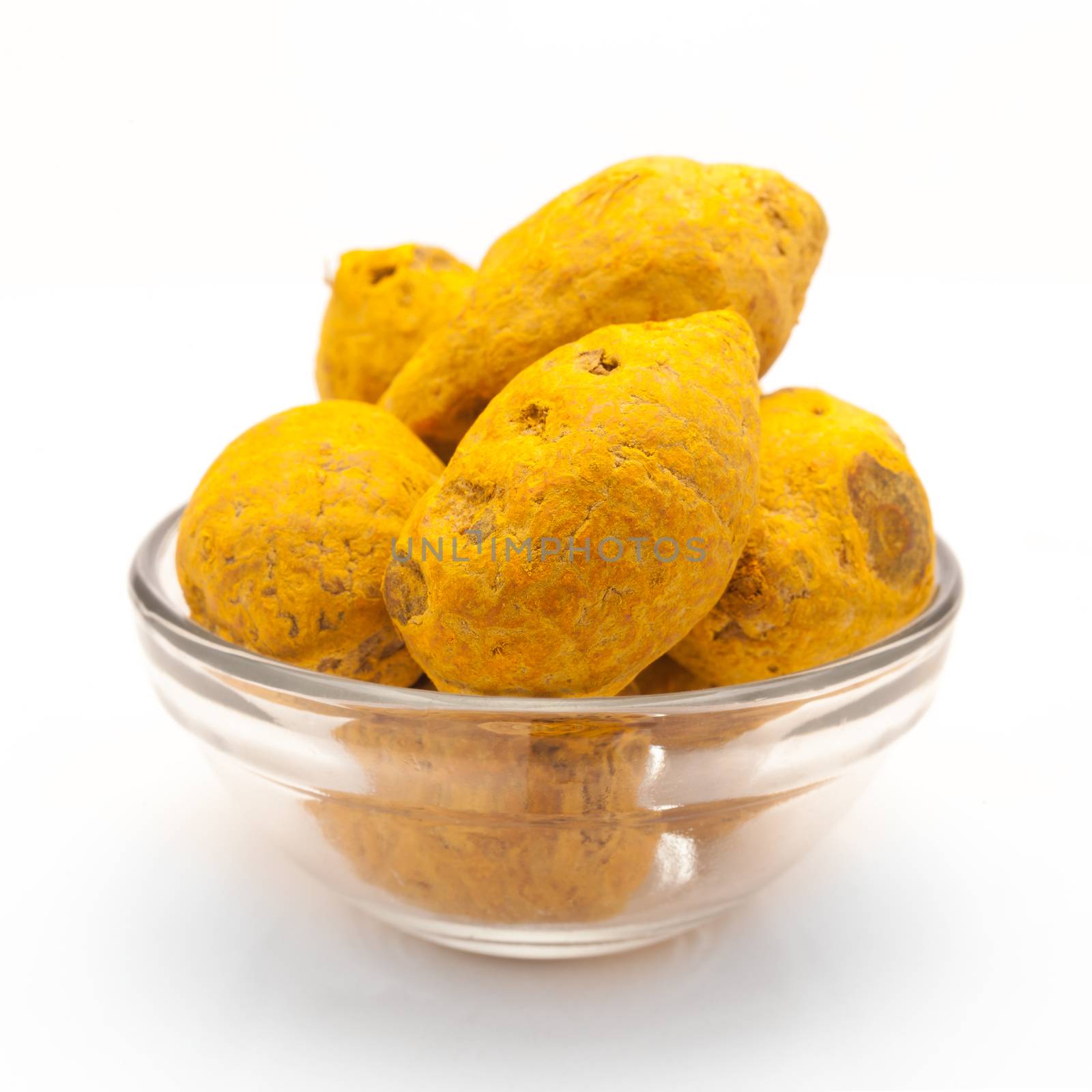 Front view of Organic Round Turmeric or Haldi (Curcuma longa) in glass bowl isolated on white background.