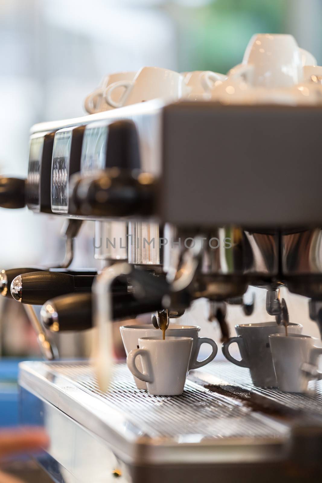 Professional coffee machine making espresso in a cafe.