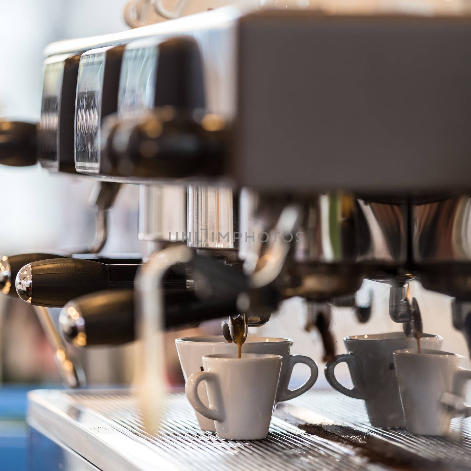 Professional coffee machine making espresso in a cafe.