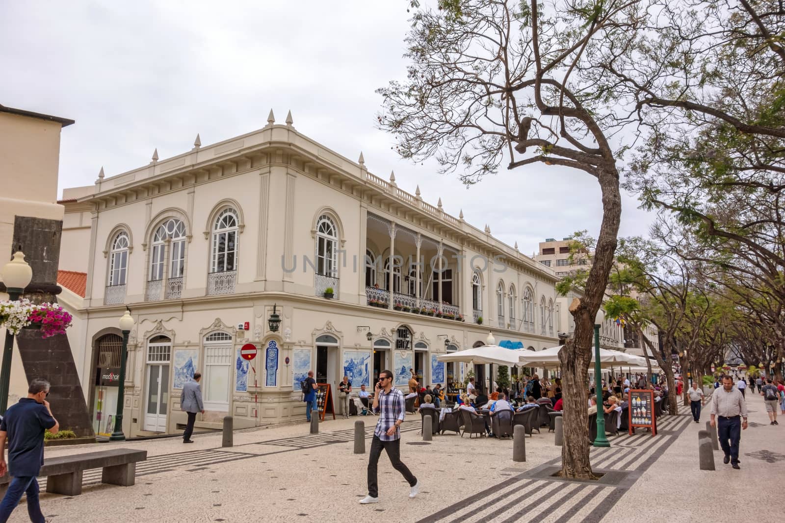 Funchal, Portugal - June 3, 2013: Avenue Arriaga in Funchal, Madeira. View of cafe / restaurant The Ritz, a popular tourist destination, not far away from the marina / harbor of Funchal.
